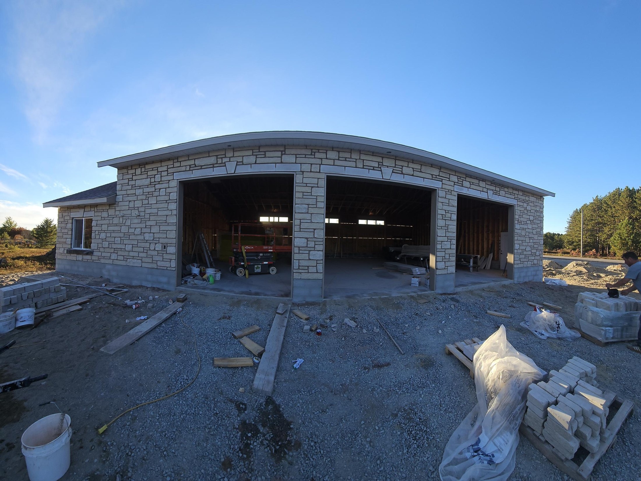 Wide view of stone veneer garage under construction, A1 Creative Masonry